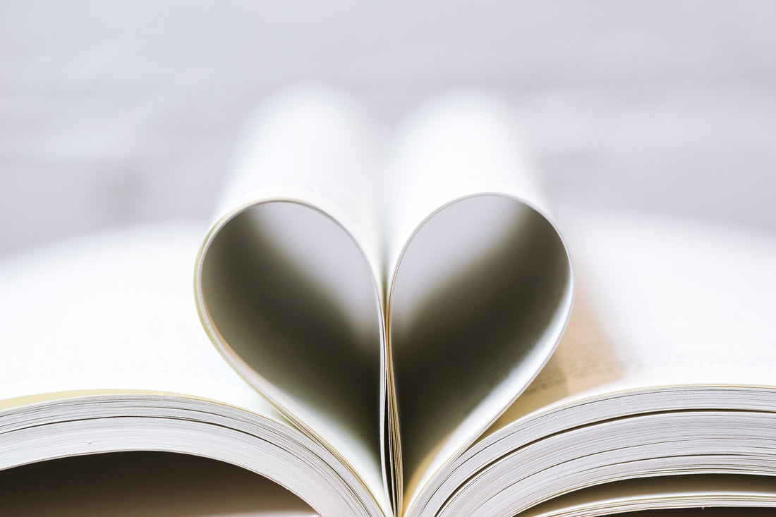 two pages from a book folded to make a heart